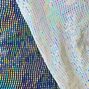 May include: Two pieces of iridescent fabric, one black and one white, with a grid pattern of small squares. The fabric is shiny and reflective.