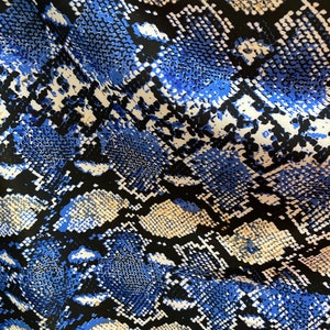 New exotic snake design taupe/sapphire/black print on poly techno 2-way stretch medium weight 58/60” Sold by the YD. Ships worldwide