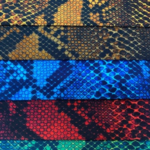 May include: Five fabric swatches with a snake skin pattern. The swatches are in different colours: brown, blue, red, green, and black.