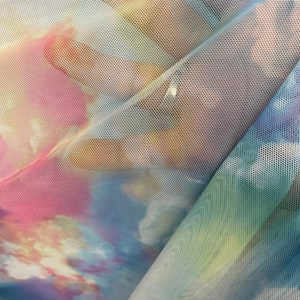 New celestial clouds design print on power mesh 4-way stretch 58/60” Sold by the YD. Ships worldwide from Los Angeles California USA.