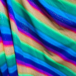 New Rainbow design with sparkling foil it glows in the dark best quality of nylon spandex 4-way stretch 58/60” Sold by the YD.