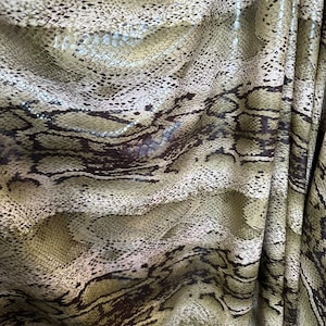 New Snake skin design print on great quality of poly spandex with clear foil 2-way stretch 58/60” Sold by the YD. Ships worldwide from L.A