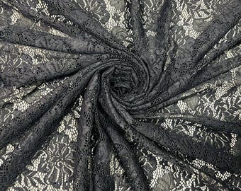 May include: Black lace fabric with a delicate floral pattern. The fabric is soft and sheer, and it has a slightly textured surface.