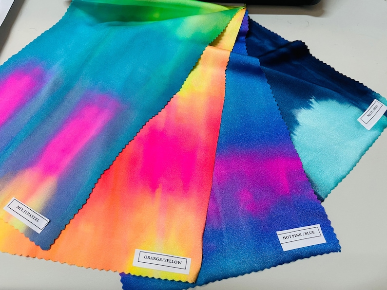 May include: Four fabric swatches with tie-dye patterns in different color combinations. The swatches are labeled "Multi Pastel", "Orange/Yellow", "Hot Pink/Blue", and "Navy/Aqua".