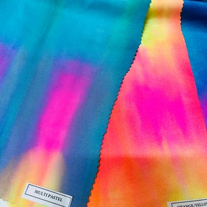 May include: Three fabric swatches with tie-dye patterns in shades of blue, pink, yellow, and orange. The swatches are labeled "MULTI PASTEL" and "ORANGE/YELLOW".