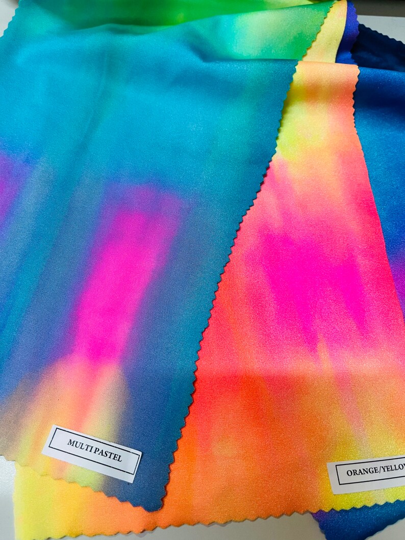 May include: Three fabric swatches with tie-dye patterns in shades of blue, pink, yellow, and orange. The swatches are labeled "MULTI PASTEL" and "ORANGE/YELLOW".