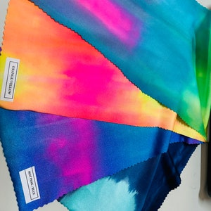 May include: Four fabric swatches with tie-dye patterns in different color combinations. The swatches are labeled "Navy Green", "Hot Pink/Blue", "Orange/Yellow", and "Blue/Pastel".