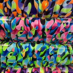 Anaconda snake design print on nylon spandex with iridescent clear foil UV light neon colors it glows in the dark 4-way stretch 58/60” Wide