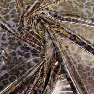 May include: Metallic gold fabric with a brown leopard print pattern.