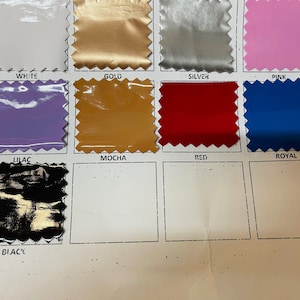 May include: A color chart of fabric swatches with the names of each color printed below. The colors include white, gold, silver, pink, lilac, mocha, red, royal, and black.