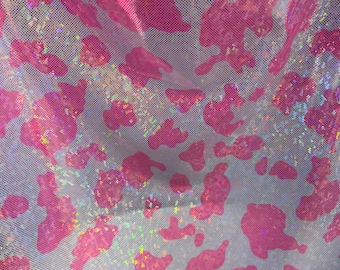 Cow design w/silver/pink on shattered glass New metallic hologram nylon spandex 4-way stretch 58/60” Sold by the YD. Ships worldwide