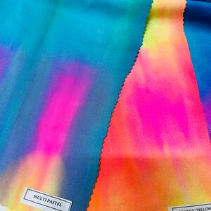 May include: Three fabric swatches with tie-dye patterns in shades of blue, pink, orange, and yellow. The swatches are labeled "MULTI PASTEL" and "ORANGE/YELLOW".