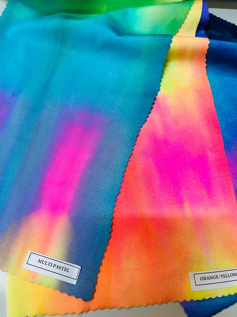 May include: Three fabric swatches with tie-dye patterns in shades of blue, pink, orange, and yellow. The swatches are labeled "MULTI PASTEL" and "ORANGE/YELLOW".