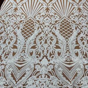 May include: White sequined fabric with a brown background. The fabric features a large-scale, intricate floral pattern.