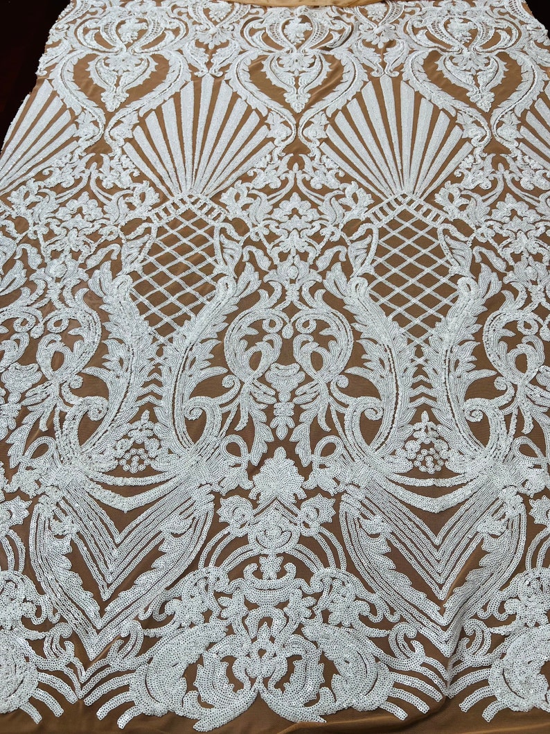 May include: White sequined fabric with a brown background. The fabric features a large-scale, intricate floral pattern.