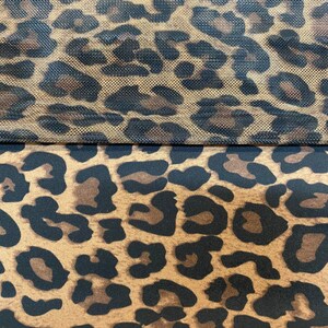 May include: Two pieces of fabric with a leopard print pattern. The top piece is a mesh fabric with a brown background and black spots. The bottom piece is a solid fabric with a brown background and black spots.