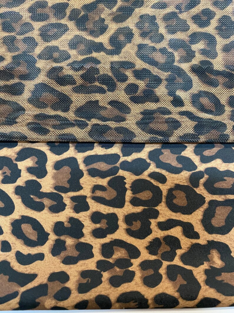 May include: Two pieces of fabric with a leopard print pattern. The top piece is a mesh fabric with a brown background and black spots. The bottom piece is a solid fabric with a brown background and black spots.