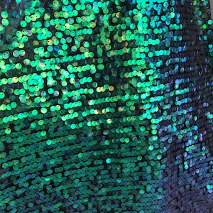Iridescent green sequins medium size 10mm sequins on spandex mesh base 58/60&quot; Sold by the YD. Ships worldwide from Los Angeles CA