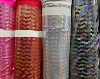 May include: Three rolls of iridescent fabric with a checkered pattern. The fabric is available in pink, silver, and black.