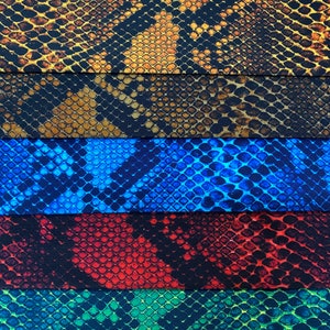 May include: Five fabric swatches with a snake skin pattern. The swatches are in the colours brown, blue, red, green, and black.