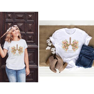 May include: White t-shirt with a floral design of lungs and the text "Your Lungs, they're small but they're strong".