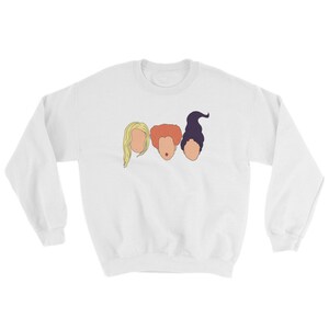 May include: White sweatshirt with a graphic of three women's faces. The women have different hair colors and styles. The graphic is a simple line drawing.
