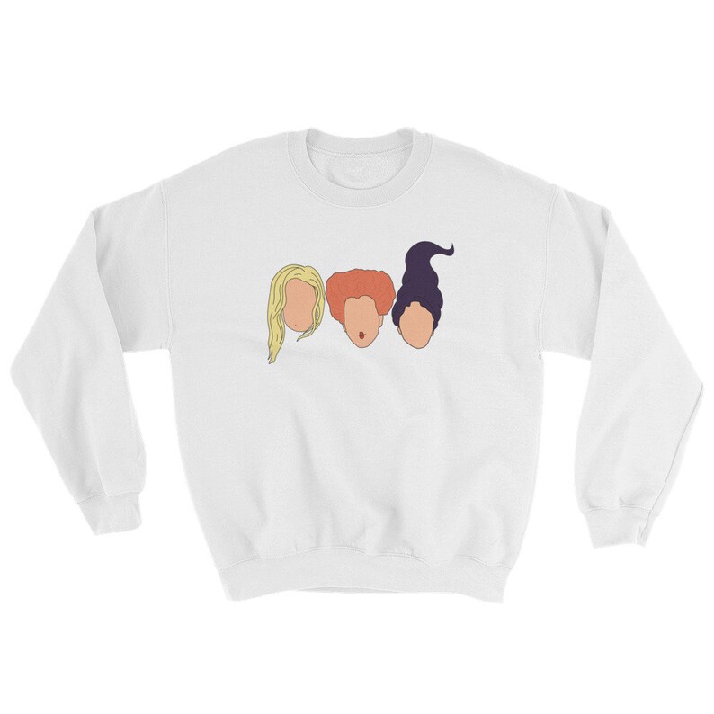 May include: White sweatshirt with a graphic of three women's faces. The women have different hair colors and styles. The graphic is a simple line drawing.