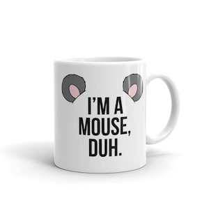 May include: White ceramic coffee mug with a black and white graphic of mouse ears and the text "I'm a mouse, duh."
