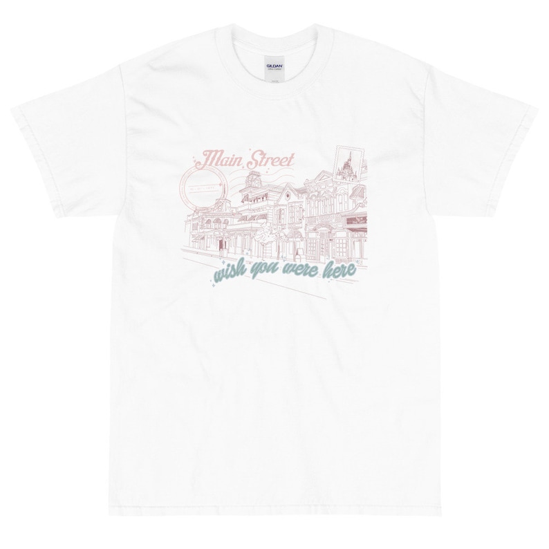 May include: White t-shirt with a pink and blue graphic design of a street scene with the text "Main Street, wish you were here."
