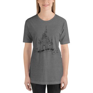 May include: A heather grey t-shirt with a black outline of Cinderella's castle and the text "Welcome to my crib".