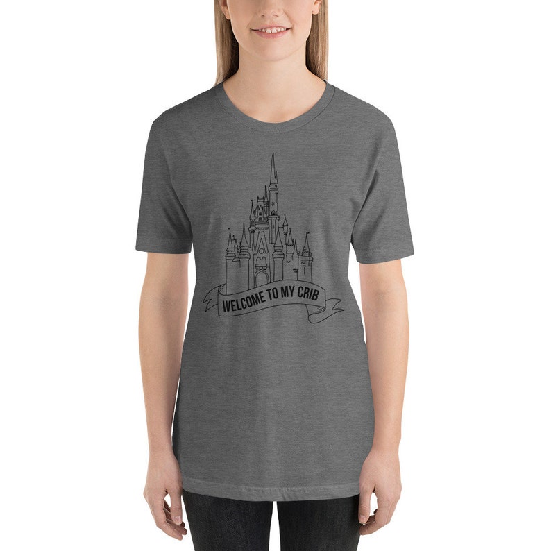 May include: A heather grey t-shirt with a black outline of Cinderella's castle and the text "Welcome to my crib".