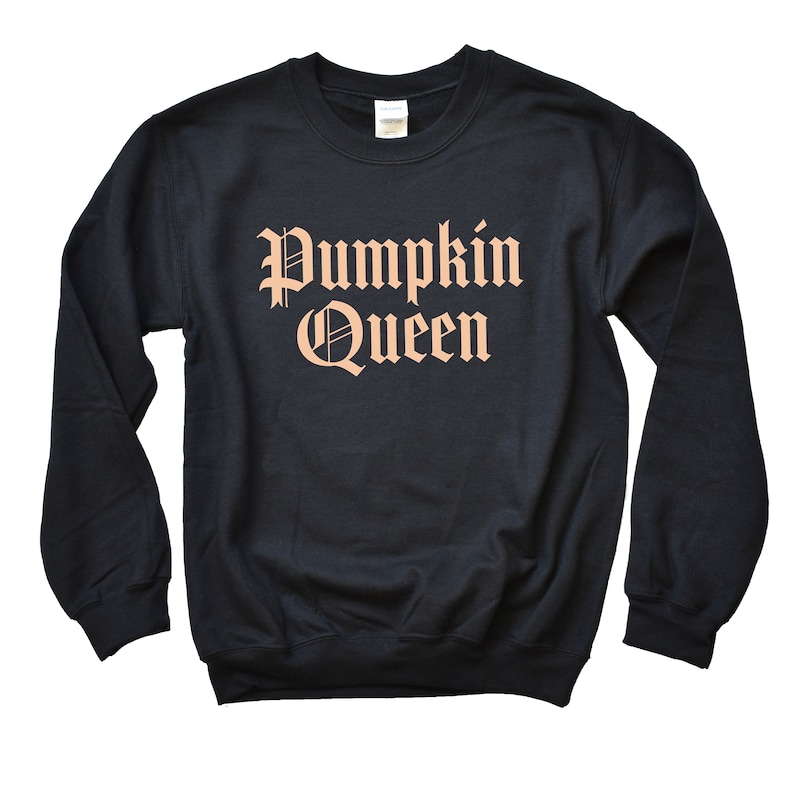 May include: Black sweatshirt with the text "Pumpkin Queen" in a peachy orange color in a gothic font.