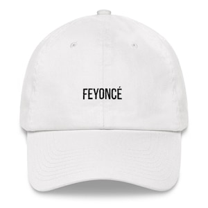 May include: White baseball cap with black embroidered text that reads "FEYONCÉ"