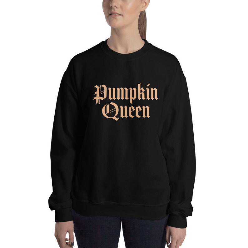 May include: Black sweatshirt with the text "Pumpkin Queen" in orange.