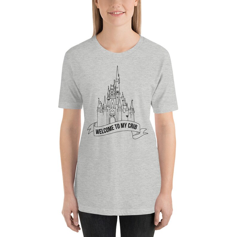 May include: A heather grey t-shirt with a black outline of a castle and the text "Welcome to my crib" on a banner.