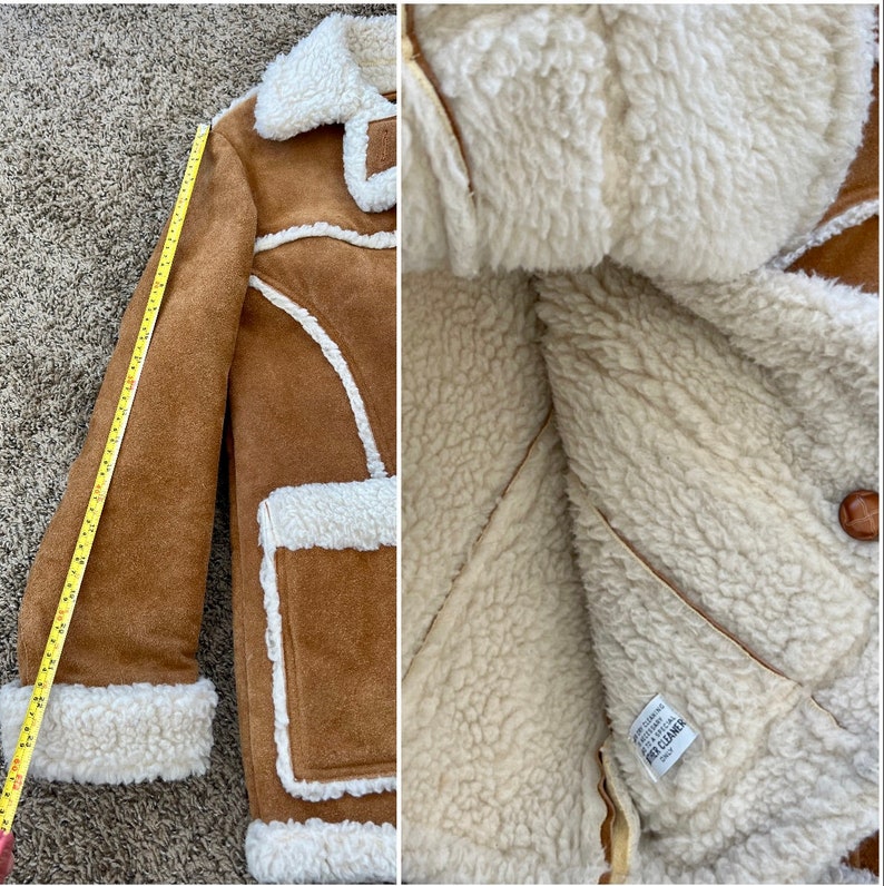 Peut inclure: Une veste en daim marron avec une doublure en peau de mouton blanche. La veste a un col, des manches longues et une fermeture &agrave; boutons. L'&eacute;tiquette &agrave; l'int&eacute;rieur de la veste indique "Cuir v&eacute;ritable, Fabriqu&eacute; en Cor&eacute;e".