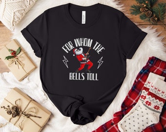May include: Black t-shirt with a graphic of Santa Claus playing an electric guitar. The text "For Whom The Bells Toll" is printed below the graphic.