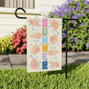 May include: A summer themed garden flag with the word "SUMMER" spelled vertically in rainbow colors. The flag is decorated with seashells and bubbles on a cream background.