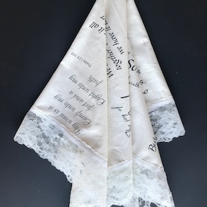 May include: A white handkerchief with a lace trim and black text that reads "But the joy of the Lord is my strength" and "Psalm 119:105".