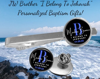 May include: A silver tie clip and a silver pin with a black and blue circular design. The design features the letter "B" and the text "Markus Bronco I Belong To Jehovah! 11-20-22".