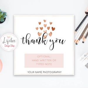 May include: A white card with a pink background and the text "Thank you" in black cursive writing. The card is decorated with a cluster of gold and pink hearts. The text "OPTIONAL: HAND WRITTEN OR TYPED NOTE" is printed in black on a pink background. The text "YOUR NAME PHOTOGRAPHY" is printed in black at the bottom of the card.