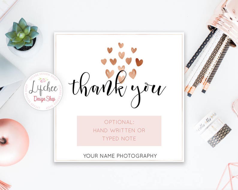 May include: A white card with a pink background and the text "Thank you" in black cursive writing. The card is decorated with a cluster of gold and pink hearts. The text "OPTIONAL: HAND WRITTEN OR TYPED NOTE" is printed in black on a pink background. The text "YOUR NAME PHOTOGRAPHY" is printed in black at the bottom of the card.