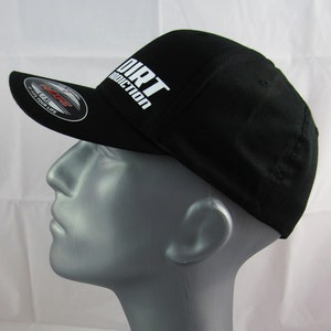 May include: Black baseball cap with a white "DIRT ADDICTION" logo on the front. The cap has a curved brim and a mesh back.