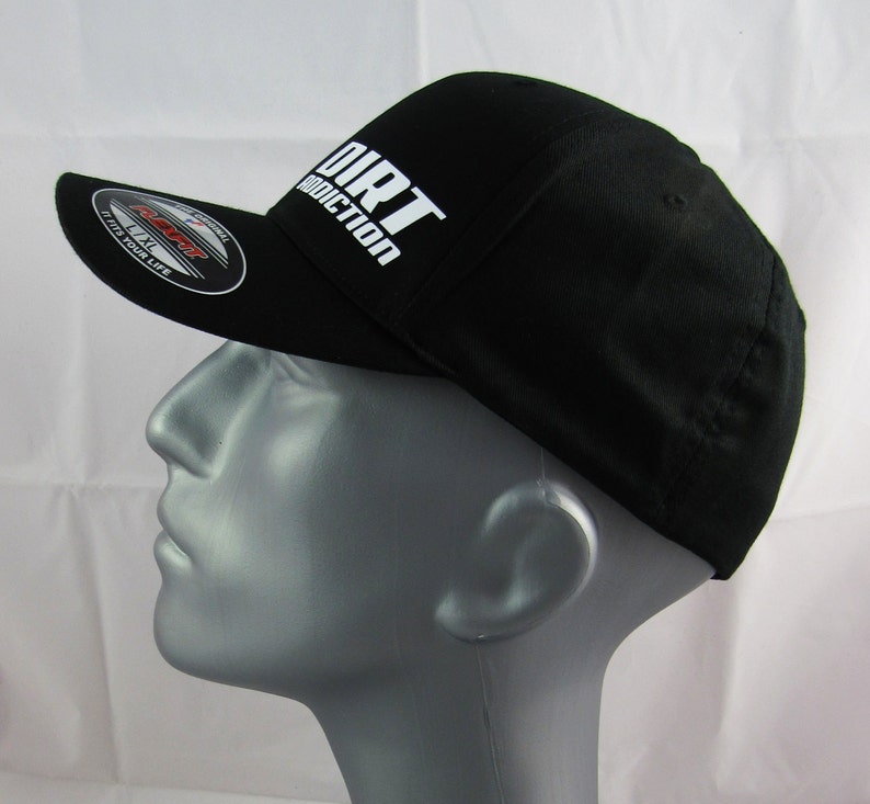 May include: Black baseball cap with a white "DIRT ADDICTION" logo on the front. The cap has a curved brim and a mesh back.