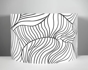 May include: Black and white lampshade with a wavy, abstract pattern.