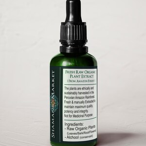 May include: A green glass bottle with a black dropper top. The bottle is labeled "Fresh Raw Organic Plant Extract [From Amazon Forest]". The label also includes information about the ingredients and origin of the product.