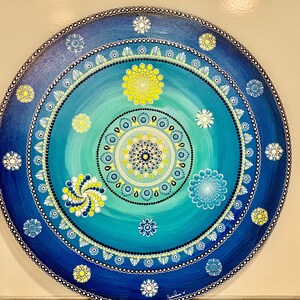Dot mandala painting, meticulously hand-crafted with intricate details using the technique of pointillism. The colors of the mandala bring a sense of peace and tranquility to any space it adorns. This is a unique pice made by Sandra Ramos