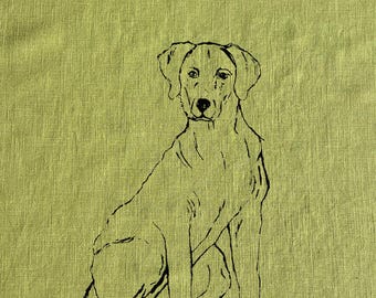 May include: A black and white line drawing of a dog sitting on a green linen background.