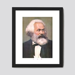May include: A framed portrait of Karl Marx, a German philosopher, economist, historian, sociologist, political theorist, journalist and revolutionary socialist. The portrait is in color and shows Marx with a white beard and mustache, wearing a dark suit and a white shirt with a black bow tie. The portrait is framed in black and has a white mat.