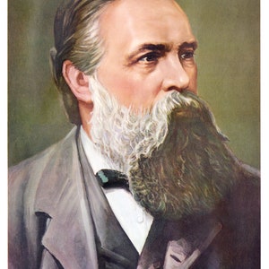 May include: A portrait of a man with a long, gray beard and mustache. He is wearing a gray suit jacket with a dark tie. The background is a muted green.